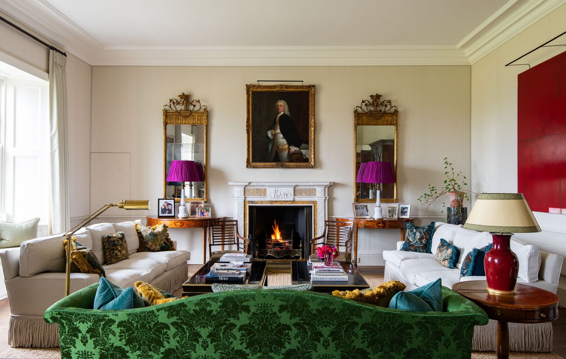 The drawing room, with a green velvet sofa before the fireplace and a portrait between gilt mirrors