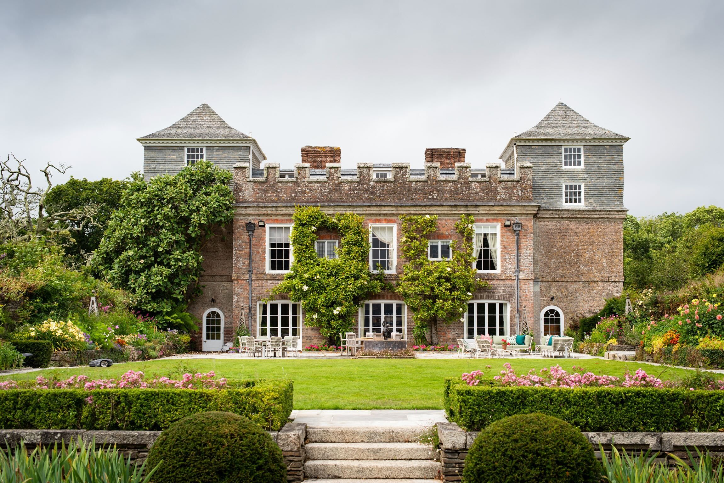 The garden front, with clipped box parterres and the two south towers