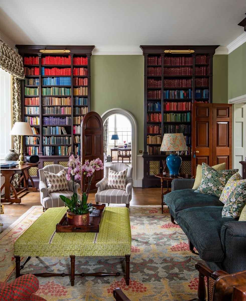 The library, with tall bookcases either side of an arched door